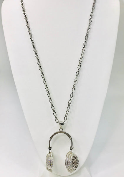 Chic headphone-inspired pendant necklace with a sleek metallic design and sparkling accents, perfect for music lovers and trendsetters.