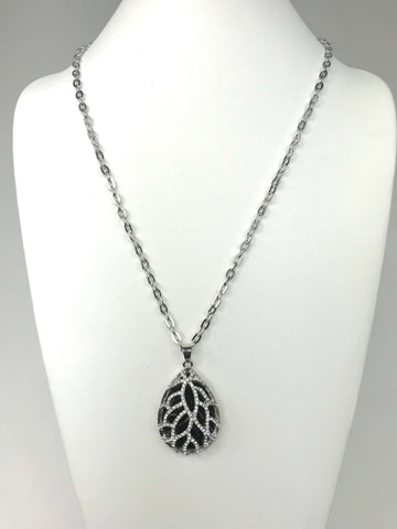 Teardrop pendant necklace with leaf design, sparkling accents, and scratch-resistant silver chain for timeless elegance.