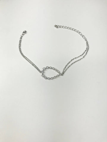 Silver-tone bracelet with double-chain, crystal-accented oval centerpiece, and adjustable lobster clasp for timeless elegance.