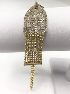 Gold-tone bracelet with hourglass design, rhinestones, beaded accents, secure clasp, and adjustable chain for a glamorous touch