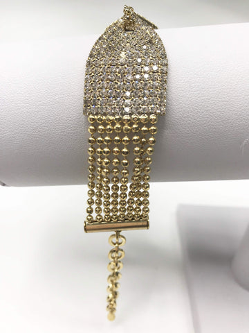 Gold-tone bracelet with hourglass design, rhinestones, beaded accents, secure clasp, and adjustable chain for a glamorous touch