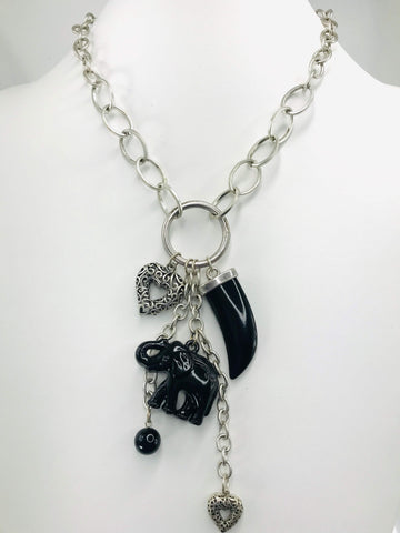 Scratch-resistant black and silver charm necklace with claw-shaped pendant, elephant charm, heart accents, and matching drop earrings.