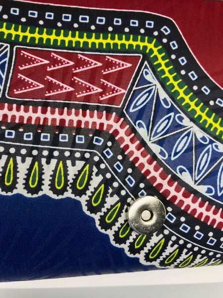 Handmade African print clutch with bold colors and playful design, perfect as a statement accessory for any adventure.