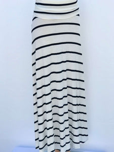 Model wearing Lines of Grace maxi skirt in black and white pattern with fold-over waistband, showing flowy silhouette and elegant drape.