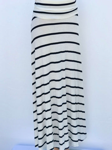 Model wearing Lines of Grace maxi skirt in black and white pattern with fold-over waistband, showing flowy silhouette and elegant drape.