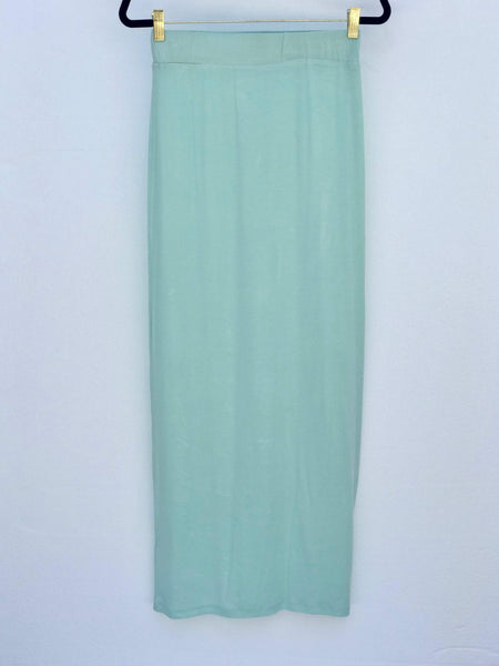 Calm Drift Aqua Maxi Skirt with flowing A-line silhouette and stretch waistband, soft cotton-blend fabric, also available in grey.
