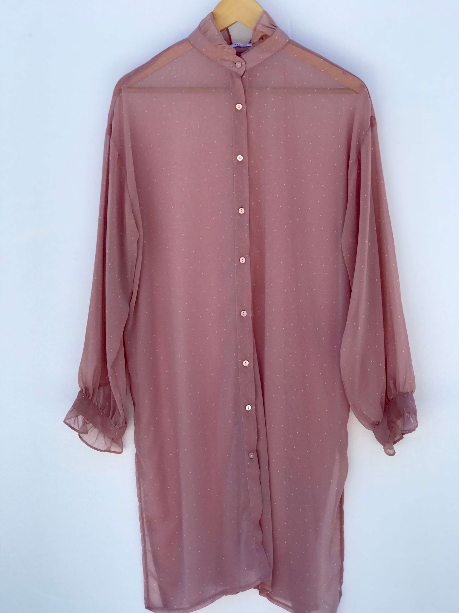 Dusty Mauve sheer polka dot blouse with flared neck and cuffs, button-up design shown on model, also available in black.