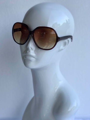 Oversized vintage-inspired sunglasses with gradient brown lenses and sleek black frames. Stylish and perfect for any outing.