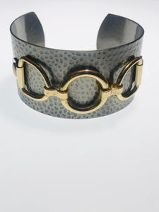 Hammered Metallic Cuff Bracelet with a textured gunmetal finish and gold-tone horse bit accents, adjustable for a timeless and elegant statement accessory