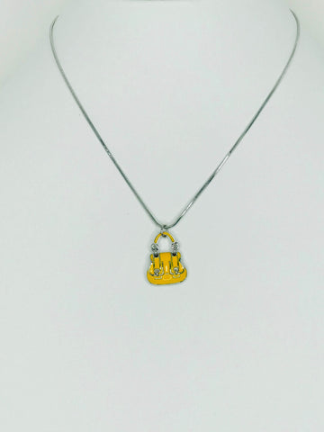 Yellow bag pendant necklace with mini tote charm on silver chain. Scratch-resistant, durable, and perfect for handbag enthusiast.