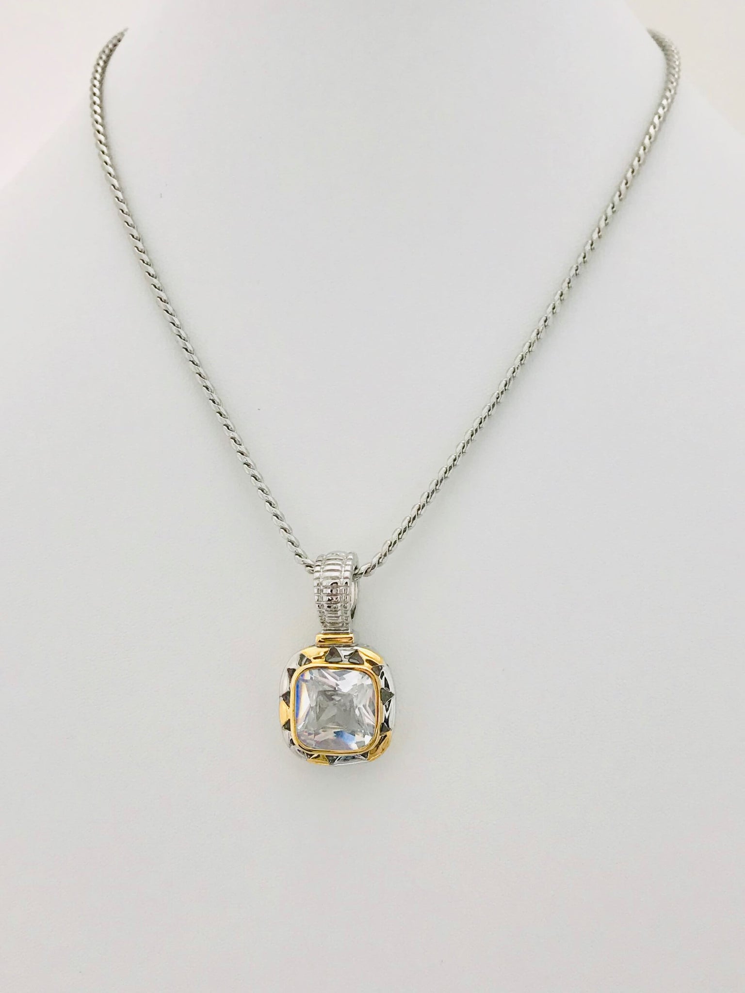 Eternal Spotlight Necklace featuring a radiant square-cut crystal in a gold-accented bezel with a silver-tone finish and twisted silver chain.