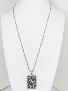 Necklace with pendant featuring silver vine design, sparkling accents, and dark background for elegant and dramatic style.